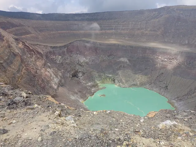 A turquoise lake inside the rocky crater of Santa Ana volcano.